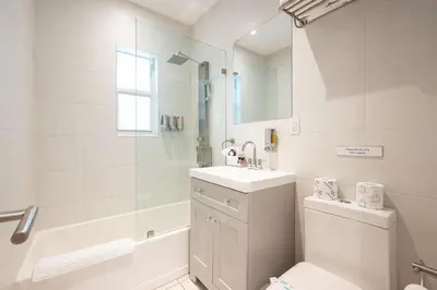 a white bathroom with a sink and a toilet at Casa Del Mar Master in Hollywood