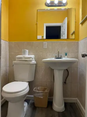 a bathroom with a toilet and a sink at Crown Inn in Fort Lauderdale