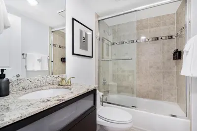 a bathroom with a sink and a toilet and a shower at Roami at Sunny Isles in Miami Beach