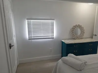 a bedroom with a blue dresser and a mirror at 1161 Studio 2 Main Miami in Miami
