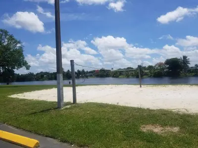 a volleyball court next to a body of water at 1161 Studio 2 Main Miami in Miami