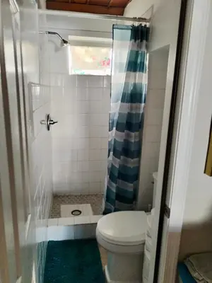 a small bathroom with a toilet and a shower at Cozy apartment in quite zone in Hollywood