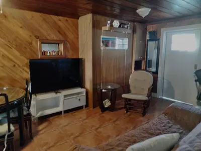 a living room with a flat screen tv and a couch at Cozy apartment in quite zone in Hollywood