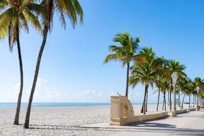 a sidewalk on the beach with palm trees at Costa Hollywood Beach Resort - An All Suite Hotel in Hollywood