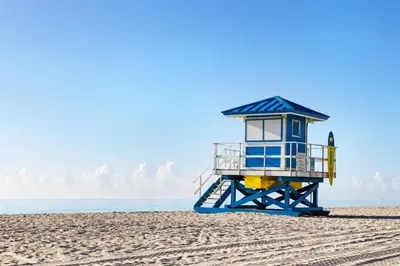 a blue and yellow lifeguard tower on a beach at Costa Hollywood Beach Resort - An All Suite Hotel in Hollywood