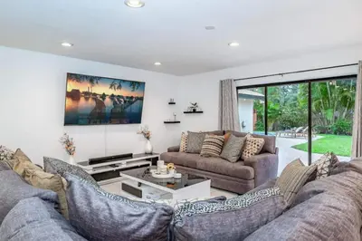 a living room with two couches and a table at Lux House Heated Spa & Free Boat Tour! in Fort Lauderdale