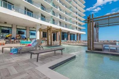 a pool at a hotel with chairs and a building at Hyde Beach Luxury Condo-Resort apts in Hollywood Beach