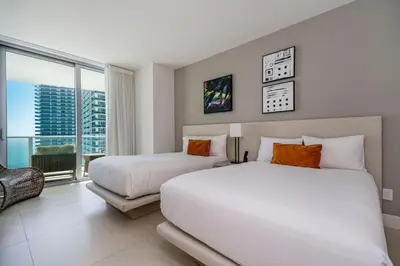 a bedroom with two beds and a large window at Hyde Beach Luxury Condo-Resort apts in Hollywood Beach