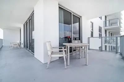 a room with a table and chairs on a balcony at Hyde Beach House Luxury Condo-Resort condo in Hollywood Beach
