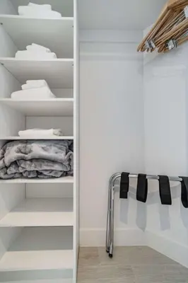 a walk in closet with white shelves at Hyde Beach House Luxury Condo-Resort condo in Hollywood Beach