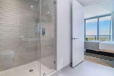 a bathroom with a shower with a glass door at Hyde Beach House Luxury Condo-Resort condo in Hollywood Beach