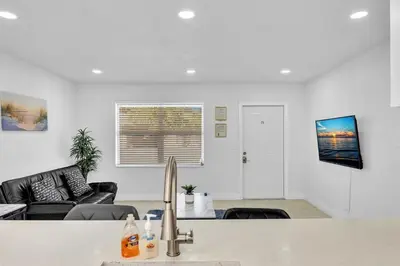 a kitchen and living room with a sink at 2 Bdrm Modern House Mins From Beach & Casino Hb1 in Hallandale Beach