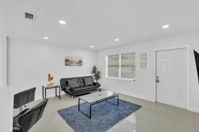 a living room with a couch and a table at 2 Bdrm Modern House Mins From Beach & Casino Hb1 in Hallandale Beach