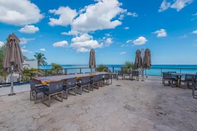 a table with chairs and umbrellas on a beach at HYDEOV1BR - Unit 1910 - Ammos condo in Hollywood Beach