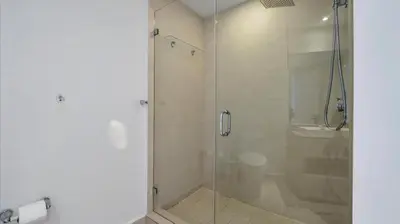 a bathroom with a glass shower with a toilet at 2 bed rental on the beach15th floor Hollywood Miami in Hallandale Beach