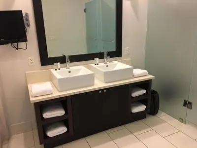 a bathroom with two sinks and a large mirror at Doral 2-Story Villa 3 Bed 4 Bath at Provident Doral at The Blue Miami in Miami
