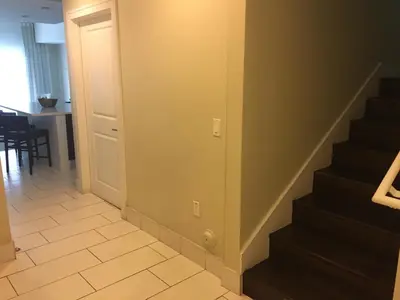 a hallway with stairs and a dining room with a table at Doral 2-Story Villa 3 Bed 4 Bath at Provident Doral at The Blue Miami in Miami
