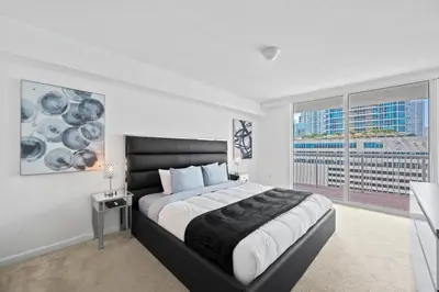 a bedroom with a large bed and a large window at Private Unit Miami With Amenities And Parking in Miami