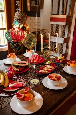a table topped with plates of food and candles at The Captain's Landing - 4 bedroom - 2 bathroom - Outdoor soaking tub - Adventure home in Fort Lauderdale