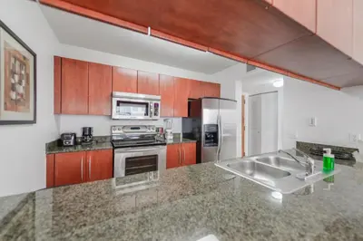 a kitchen with stainless steel appliances and a counter top at Spectacular apartment in Heart of Brickell in Miami