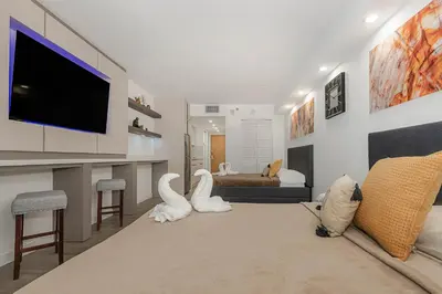 a living room with a flat screen tv on a wall at High Rise Brickell Modern Studio in Miami