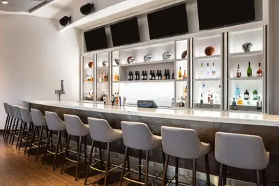 a bar with a row of stools in a room at Courtyard by Marriott Miami Airport in Miami