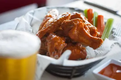 a bowl of food with meat and vegetables and a beer at Courtyard by Marriott Miami Airport in Miami