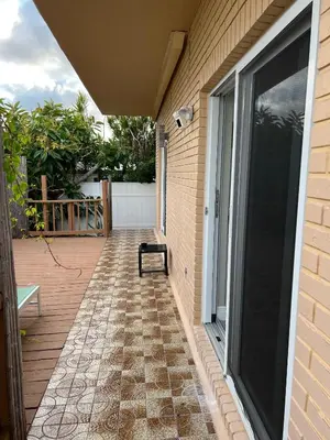 a patio with a bench on the side of a house at The Tel in Hollywood