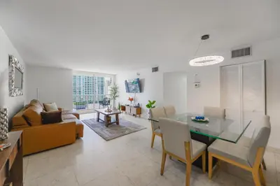 a living room with a table and a couch at Gorgeous Apartment in Brickell in Miami