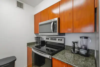 a kitchen with a stove and a microwave at Gorgeous Apartment in Brickell in Miami