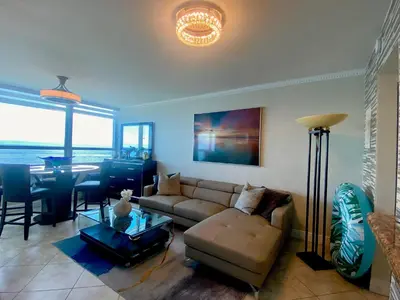 a living room with a couch and a table at Castle Beach Resort Condo - Panoramic Large Penthouse or Deluxe 1 BR Direct Ocean View and beach access- Updated-Free parking- in Miami Beach