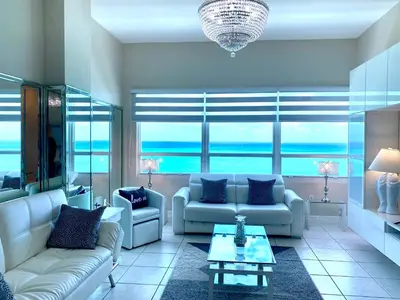 a living room with two couches and a table at Castle Beach Resort Condo - Panoramic Large Penthouse or Deluxe 1 BR Direct Ocean View and beach access- Updated-Free parking- in Miami Beach