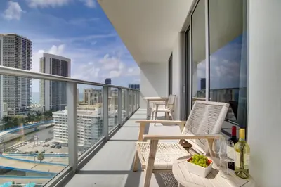 a balcony with chairs and a view of the city at Upscale Condo with Pool Access in Hyde Beach House! in Hollywood