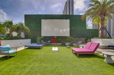 a garden with chairs and a large screen at Upscale Condo with Pool Access in Hyde Beach House! in Hollywood