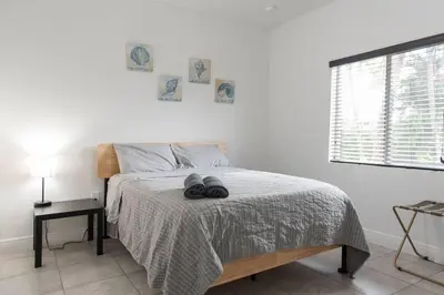 a bedroom with a bed with two pairs of shoes on it at New house on the block near Miami Airport. in Miami