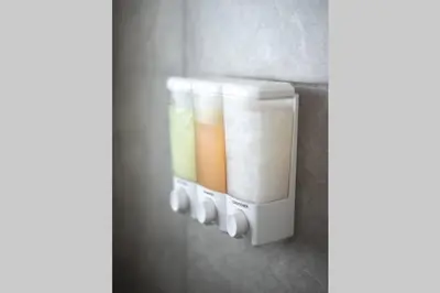 a soap dispenser hanging on a wall at New house on the block near Miami Airport. in Miami