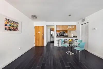 a kitchen and dining room with a table and chairs at Brickell Apartments with Oceanview in Miami