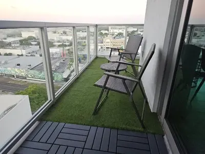 two chairs on the balcony of a building at Desing district, great apartment in Miami