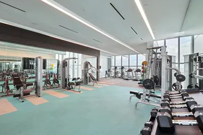 a gym with treadmills and machines in a building at Desing district, great apartment in Miami
