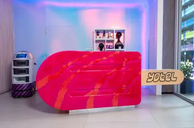 a red couch in a room with a table at YOTEL Miami in Miami