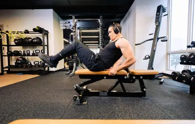 a man sitting on a bench in a gym at YOTEL Miami in Miami