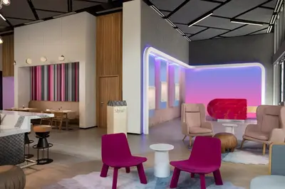 a waiting room with purple chairs and a red couch at YOTELPAD Miami in Miami