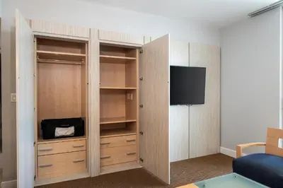 a room with a closet with a flat screen tv at Sunny Isles 1BDR Sea View and Pool in Miami Beach
