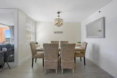 a dining room with a table and chairs at Yacht Club at aventura Amazing Marina view parking included in Miami