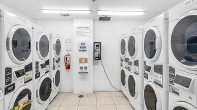 a row of washing machines in a laundry room at SeaStays Apartments in Miami Beach