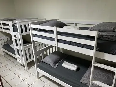 two bunk beds in a room next to each other at Single Size BOTTOM Bunk Bed - Mixed Shared ROOM in Miami