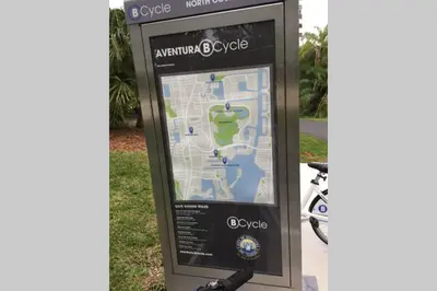 a sign with a map next to a bike at Renovated cozy The yacht club at aventura Parking included in Miami