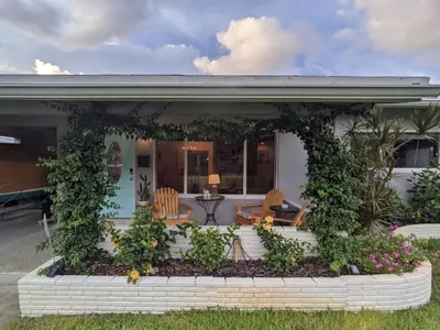 a house with a garden in front of it at Surf House - Paddleboards - Canoes -1 mile to Wilton Manors in Fort Lauderdale