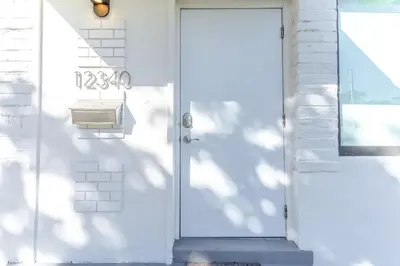 a white door with a mailbox next to it at Renovated Apts with Kitchen, Fast WiFi, Smart TV, Roku & Pool Onsite 4 mi to Surfside Beach in North Miami
