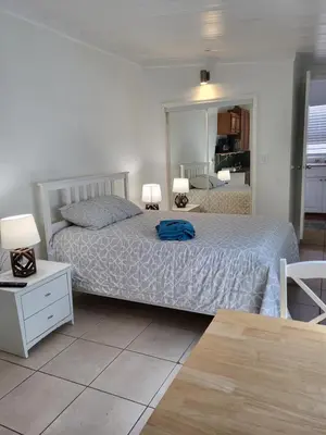 a bedroom with a bed with a blue bag on it at 13101 Main Apartment Miami in Miami